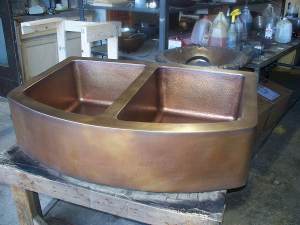Solid Bronze Copper Farm Style Kitchen Sink with a smooth outer finish and a hammered interior.