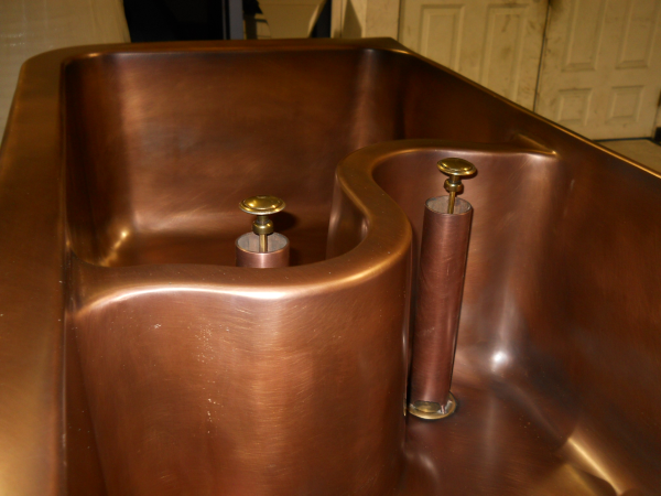 Solid Bronze Copper Farm Style Kitchen Sink with a smooth outer finish and a hammered interior.  Solid copper, Polished Nickel, or Stainless Steel kitchen sinks farm style as well as under mountable are very popular in the luxurious kitchen.